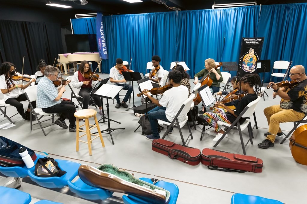 Students in drumming and vocal music sessions