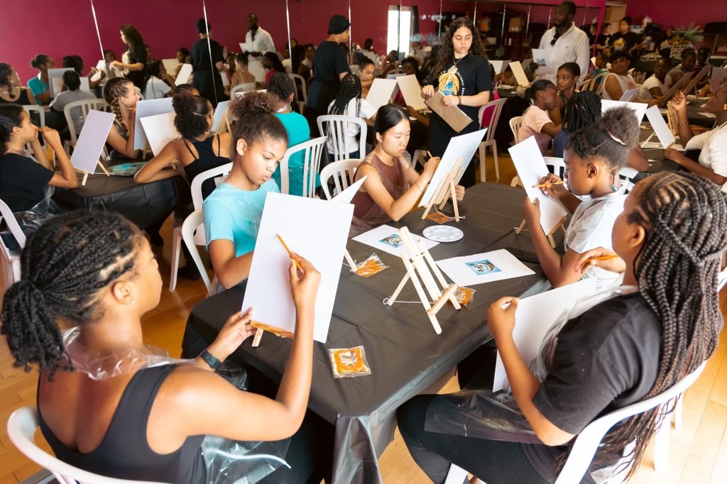 Students creating paintings and mixed media artwork