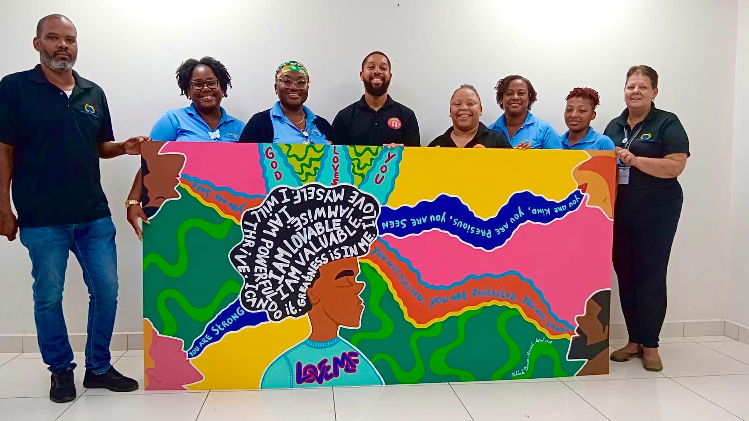 Representatives present the collaborative mural during Foster Care Awareness Month