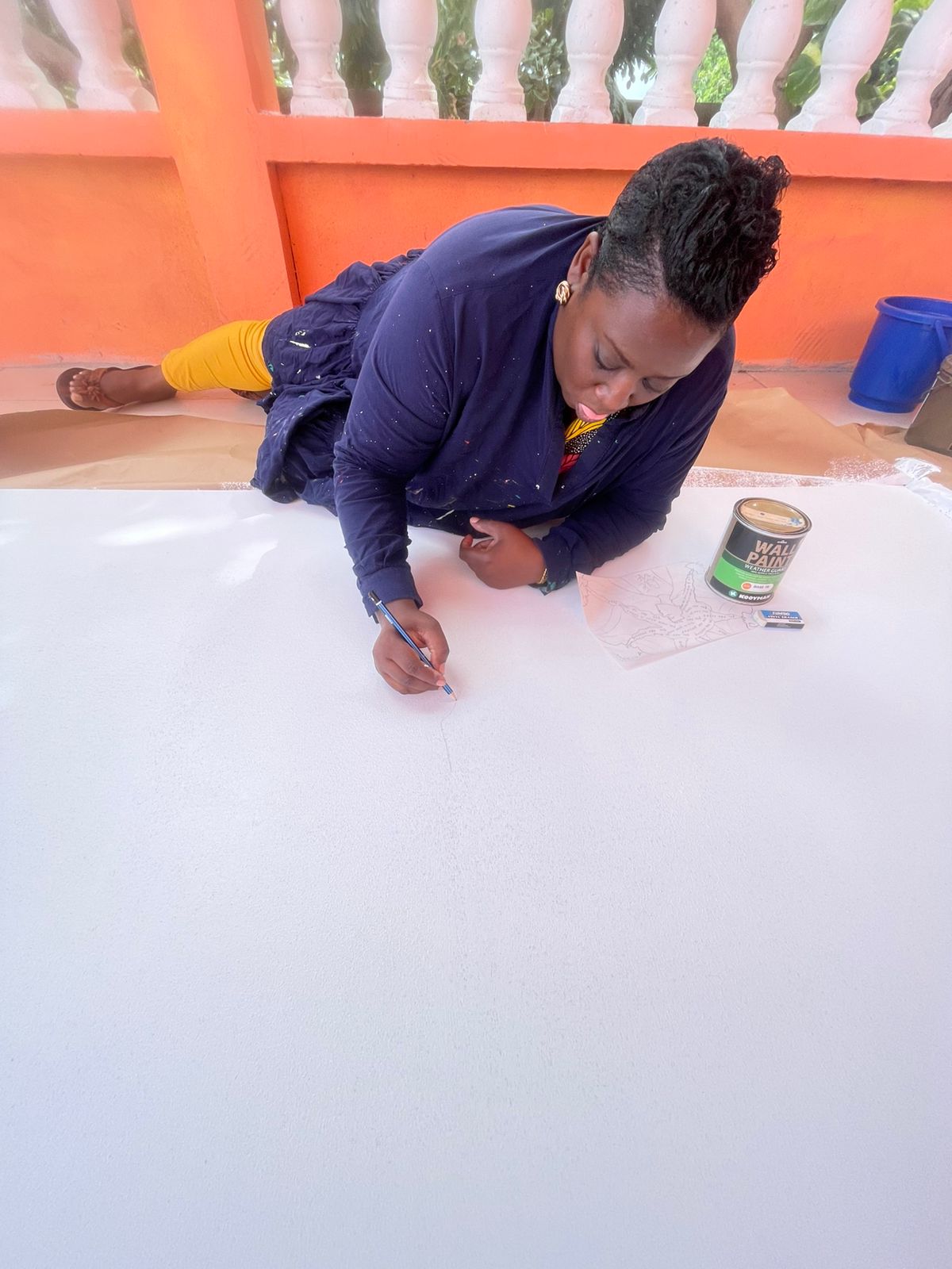 Teaching artist Zillah Duzon Hazel begins sketching the mural design